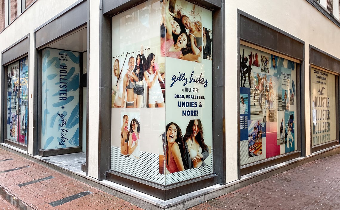 Hollister store with temporary window graphics advertising promotional sales